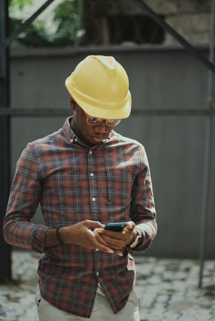 Tradesman checking a missed call text back reply on his phone